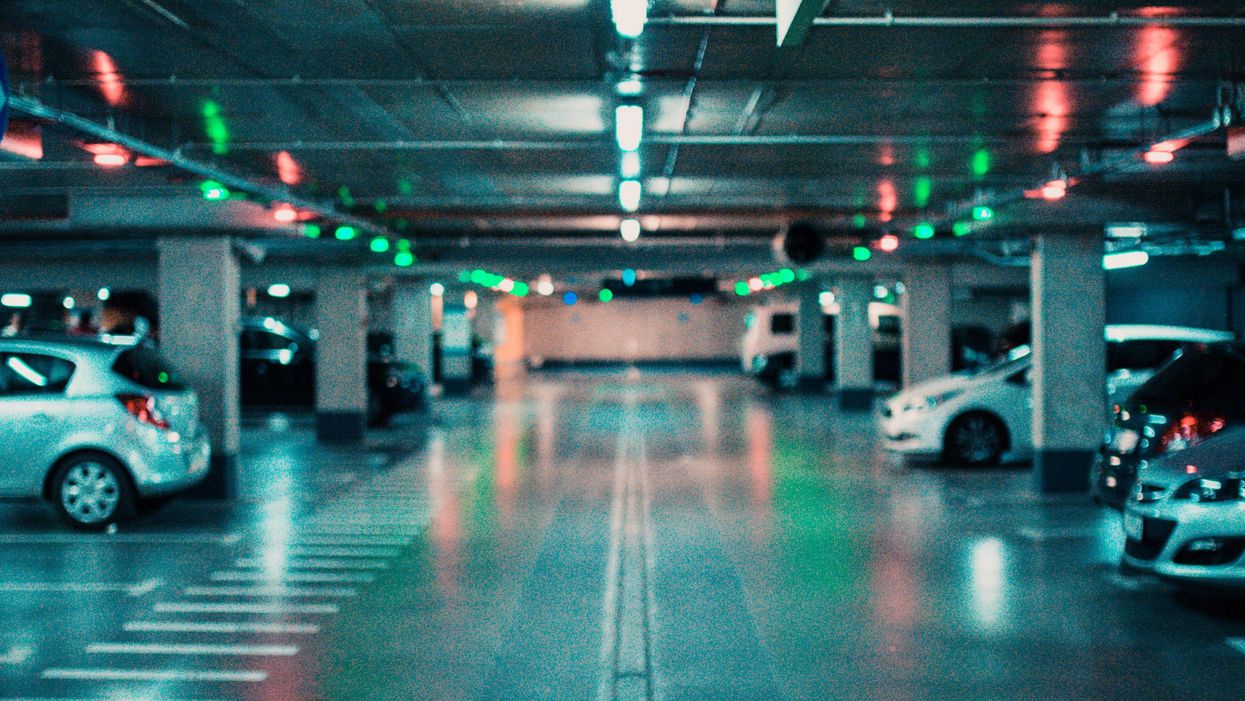 A parking garage with some empty spaces.