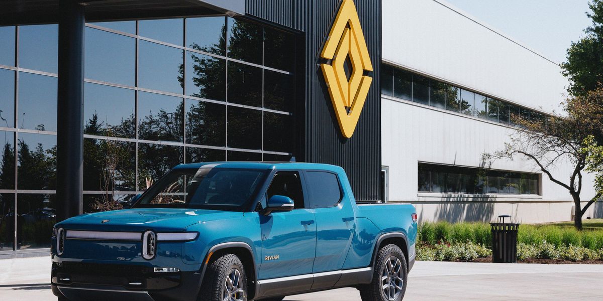 An R1T in Rivian Blue at the main entrance to the plant in Normal, IL.\u200b