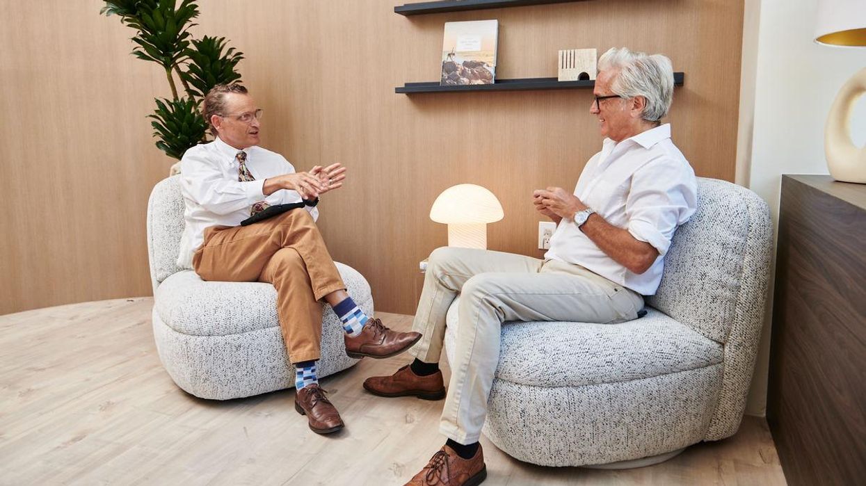 Antonio Ocana (left) sitting down with another person in the Pasithea clinic.
