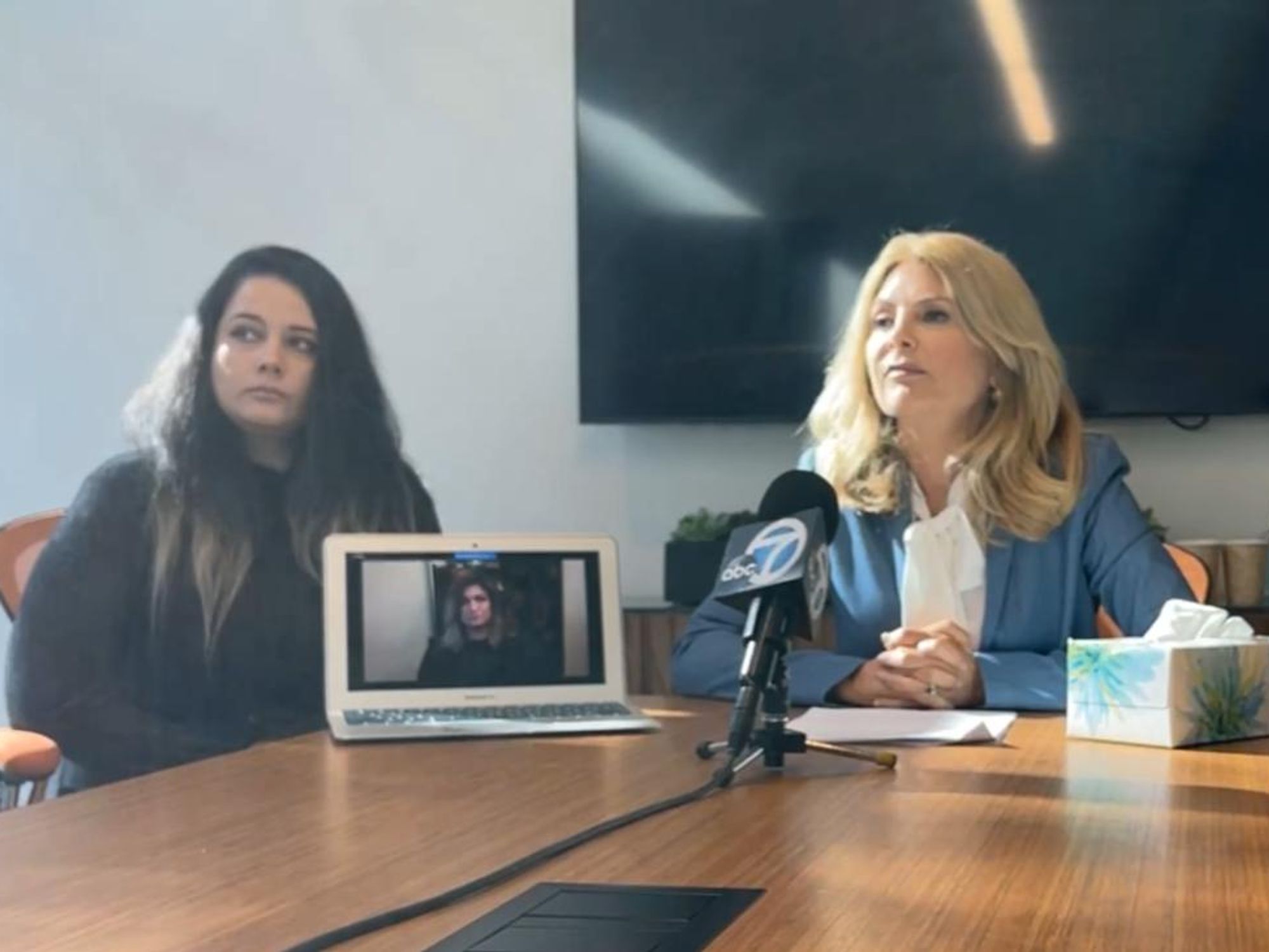 isa Bloom sits in front of the mic with the women who are suing Activision Blizzard.