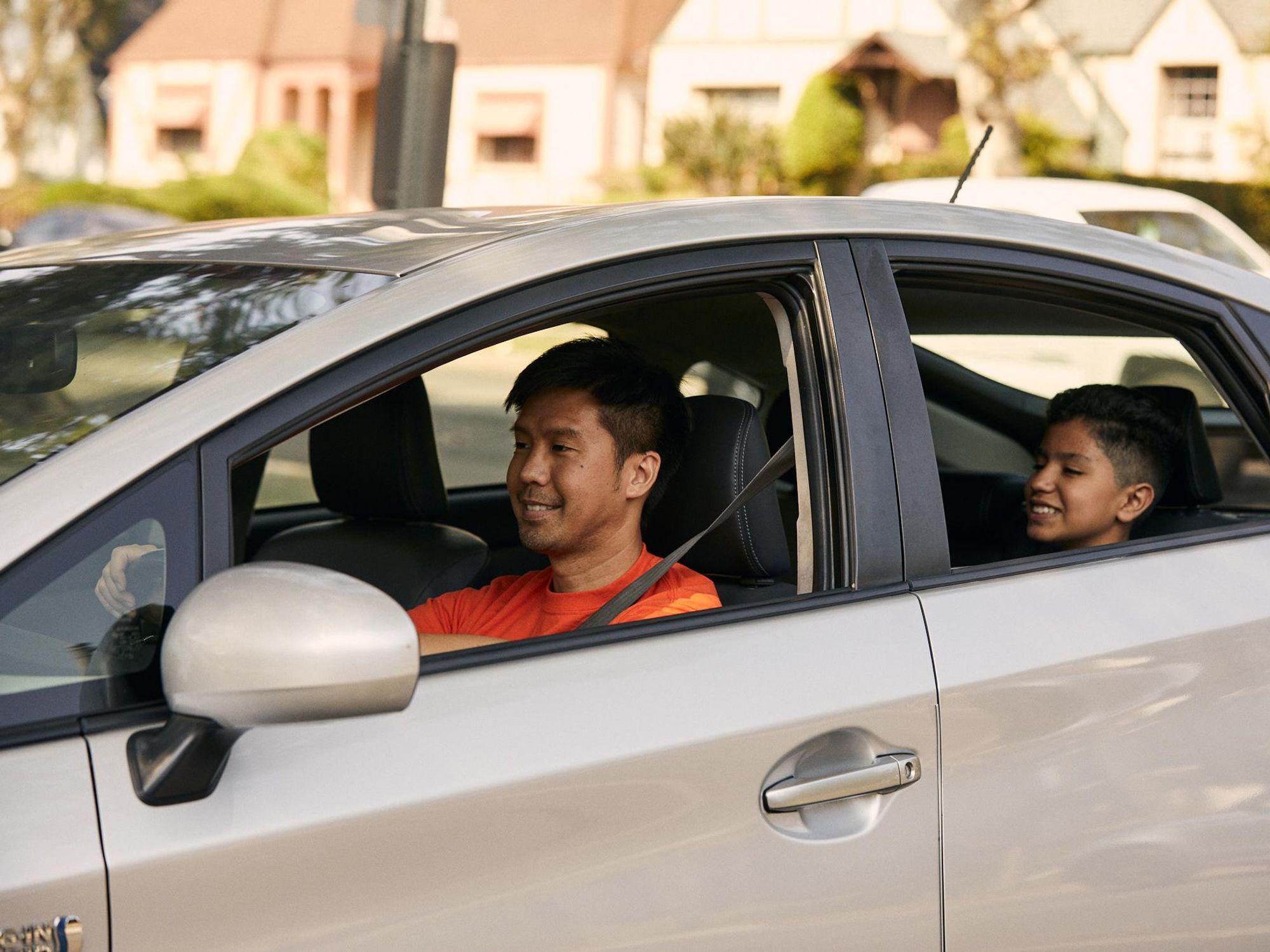 Man and child riding in car