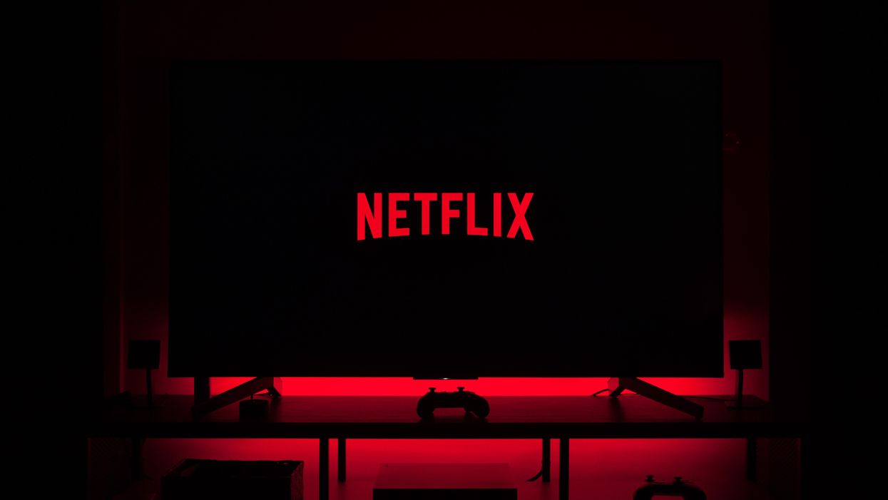 Netflix logo on a TV with red LED backlight behind TV
