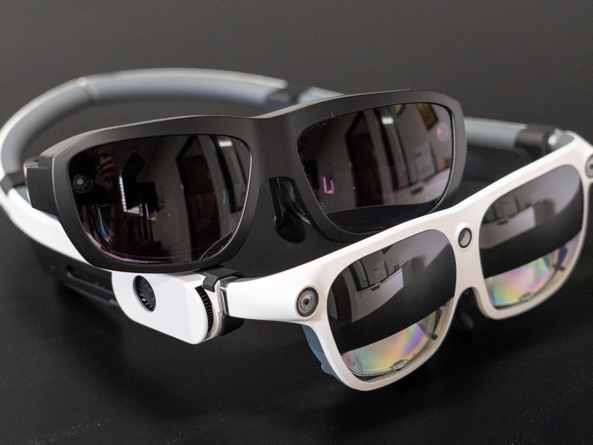 Pairs of Eyedaptic AR glasses.