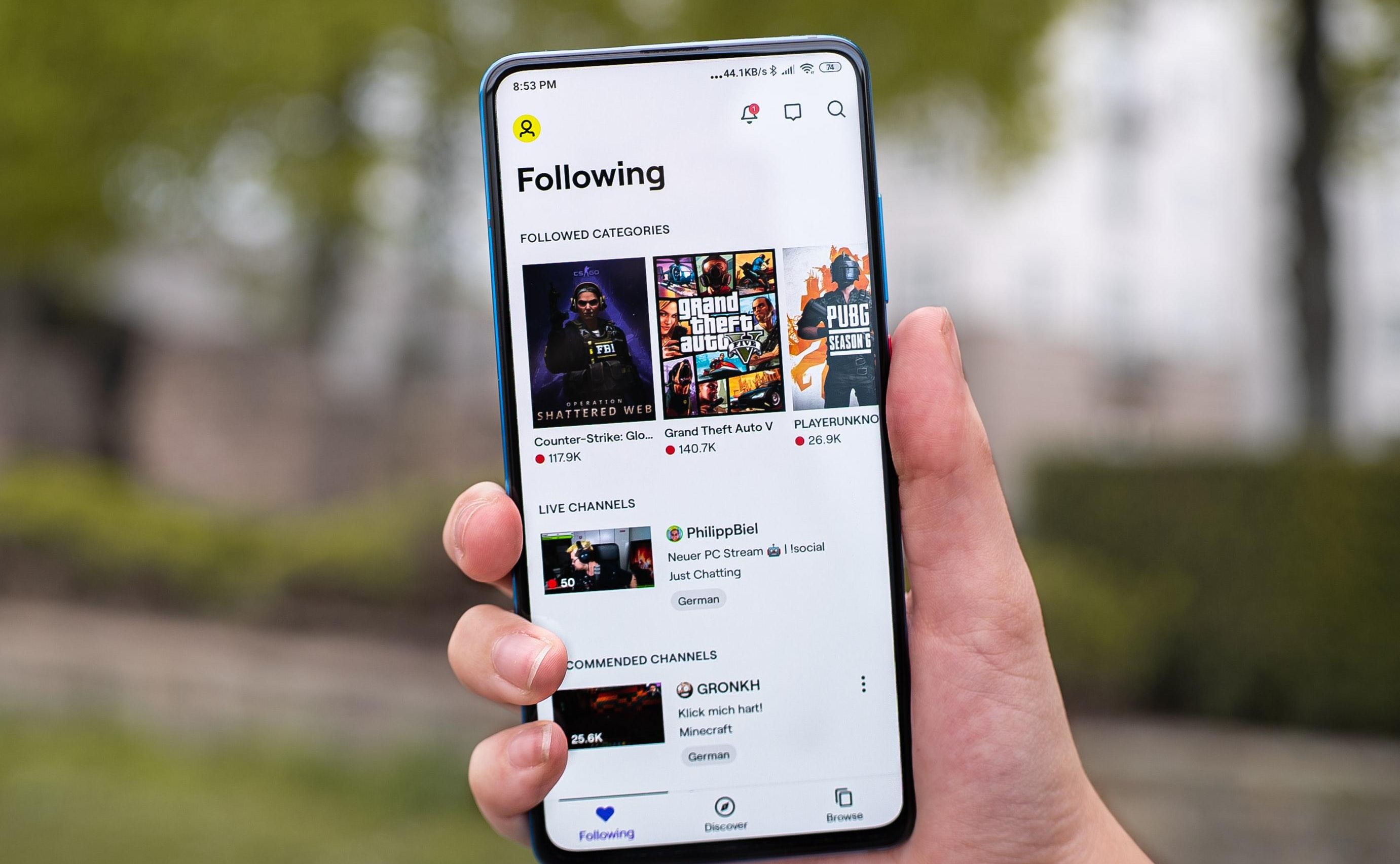 person holding a phone with videos