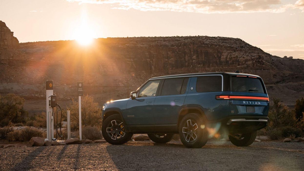 Rivian R1S at a charging station in the desert.