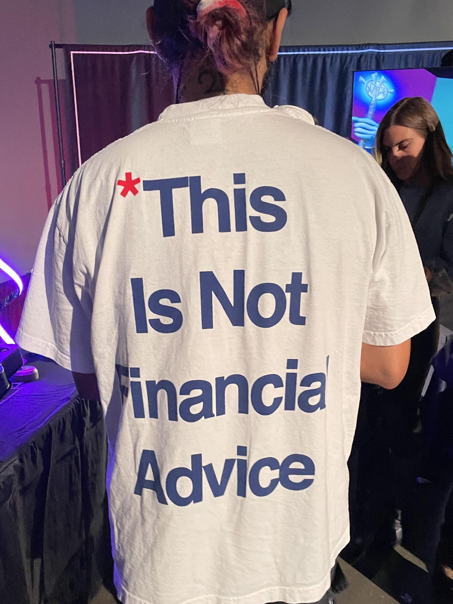u200bA t-shirt reading u201c*This Is Not Financial Adviceu201d at the NFT LA conference.