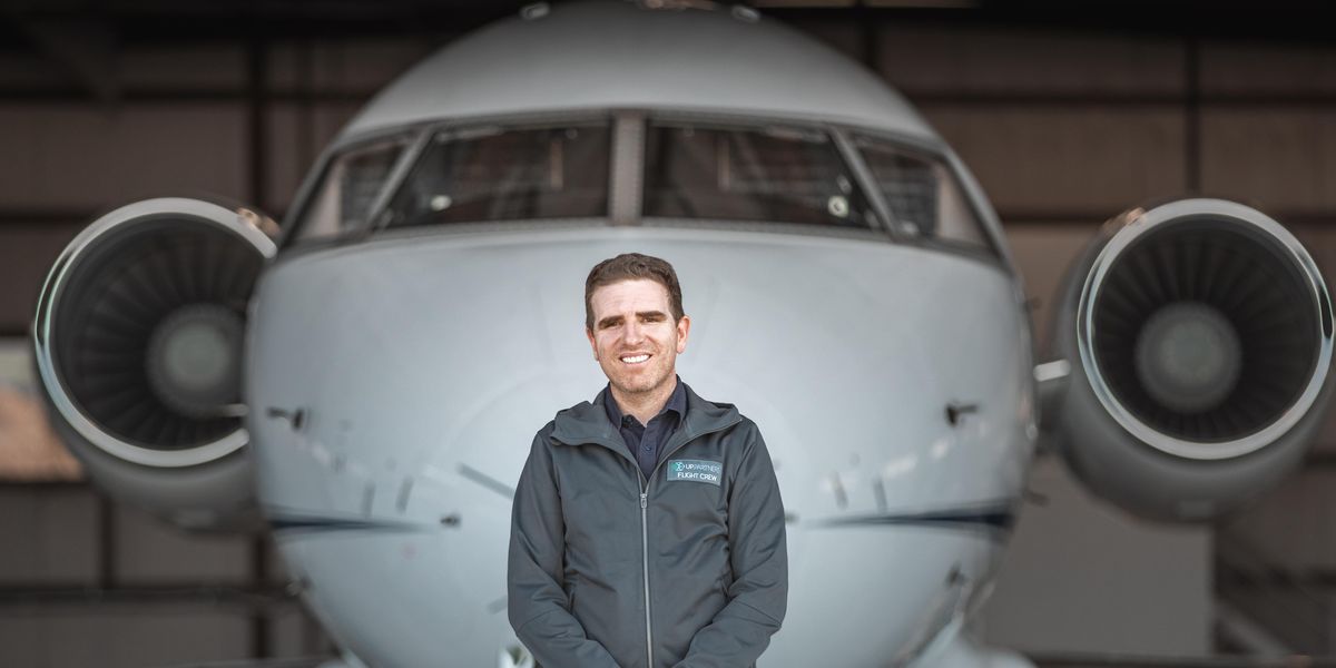 UP Partners’ Ben Marcus stands in front of a airplane.