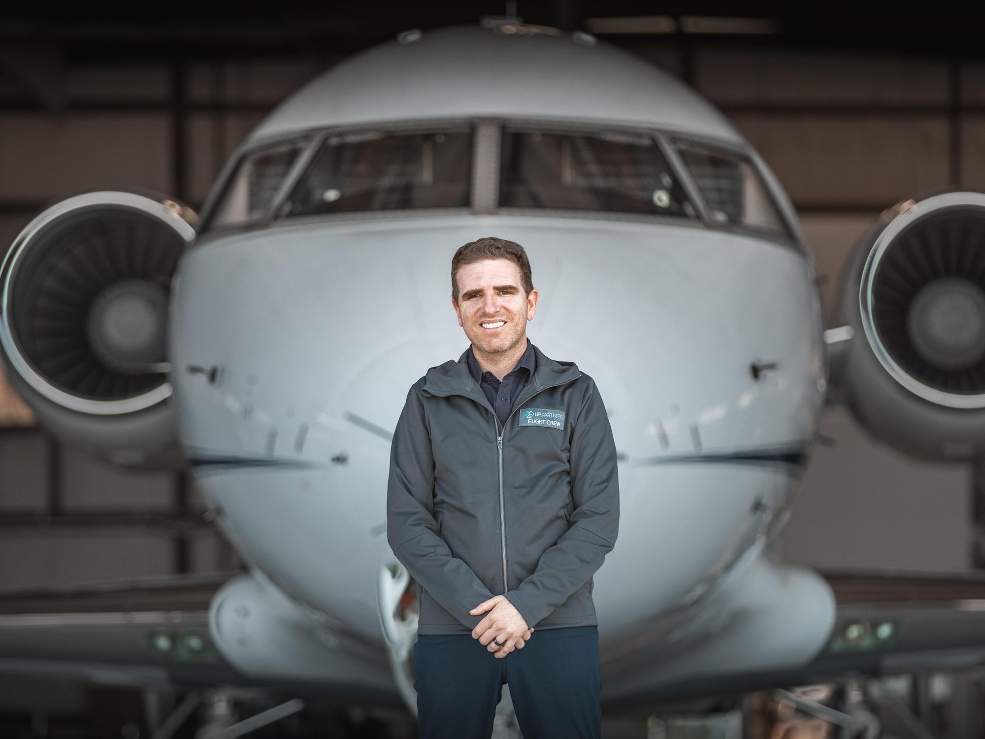 UP Partners’ Ben Marcus stands in front of a airplane.