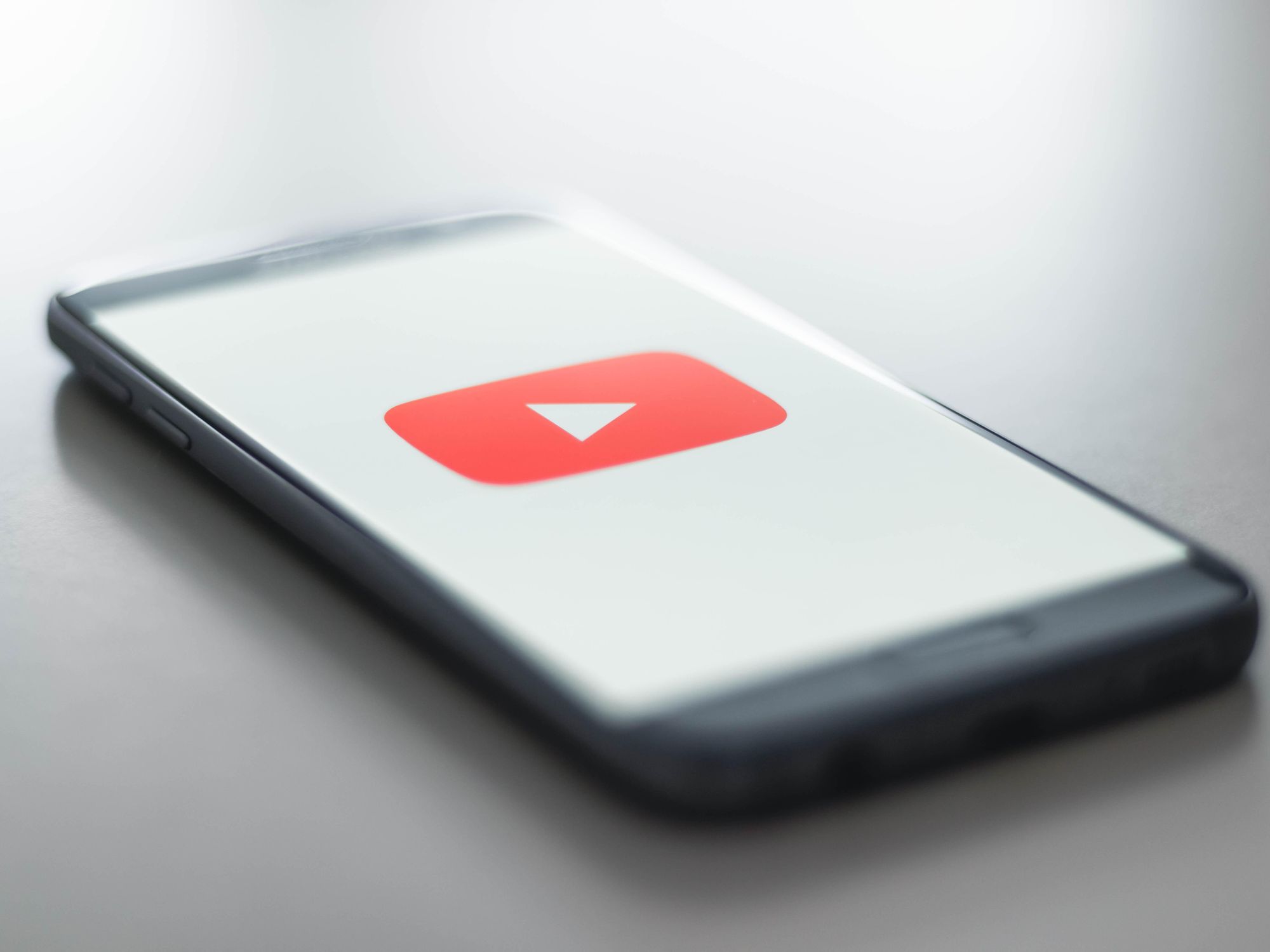 Youtube symbol on a smartphone with edges blurred. 